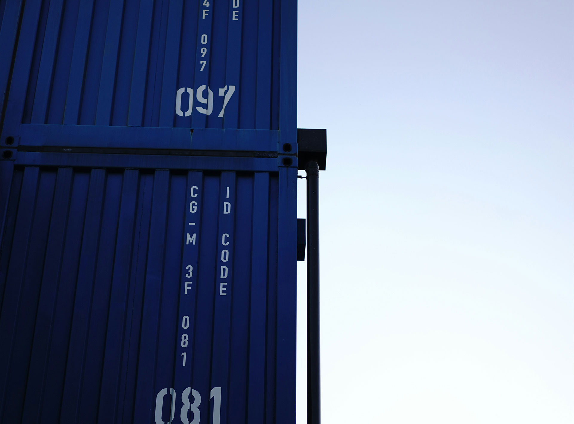 a-tall-blue-container-sitting-on-top-of-a-metal-pole